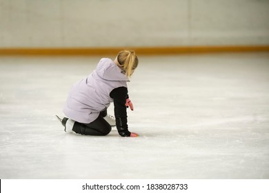 Kid Fall On The Ice Rink. Figure Skating School. Young Figure Skaters Practicing At Indoor Skating Rink. Kid Learning To Ice Skate.