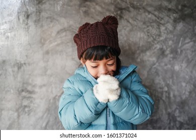 Kid Feeling Expression Concept. Asian Child Girl Wear Winter Coat Jacket Fells Very Cool During Winter Season. Small Girl Shiver In Cold Weather Headwear.