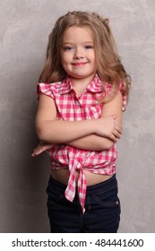 Kid With Folded Arms. Close Up. Gray Background