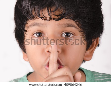 kid gesturing to maintain silence 