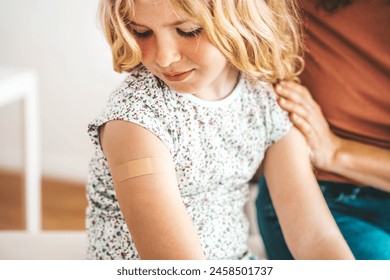 Kid getting vaccinated in clinic room - Children vaccination and childhood health care concept - Powered by Shutterstock