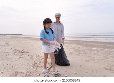 Kid Girl With Grandmother Garbage Clean Up On The Beach 