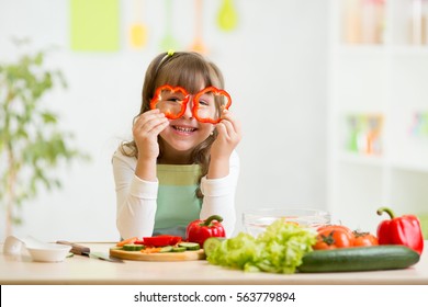 kid girl having fun with food vegetables at nursery room