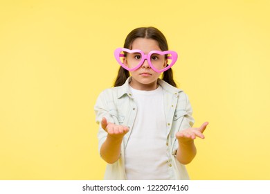 Kid Girl Heart Shaped Eyeglasses Looks Disappointed. Girl Wear Cute Eyeglasses Disappointed Face. What Just Happened. She Asks You. Child Dissapointed Confused What Going On. Disappointment Concept.