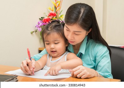 Kid Girl And Her Mom Reading And Writing A Book Together