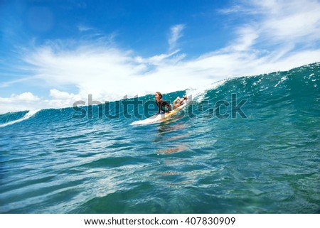 Kid girl is learning surfing, riding a wave