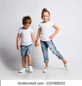 Kid Girl And Little Boy Preschoolers Are Dancing, Practicing Dance Moves, Playing Dance TV Show On White With Background. Childhood, Freedom, Playground And People Concept