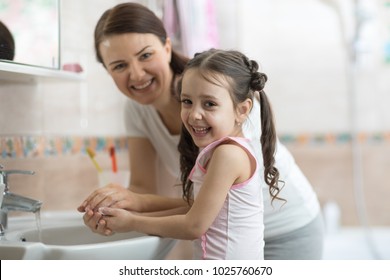 Kid Girl With Mom Washing Her Hands In Bathroom