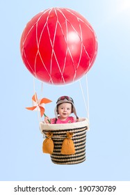 Kid Girl On Hot Air Red Balloon In The Blue Sky