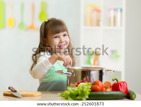 Similar – Foto Bild Kind Mädchen hilft Mama, frisches Gemüse zu kochen und zu schneiden.