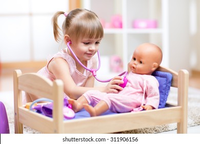 child playing with dolls