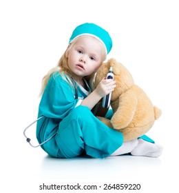 kid girl playing doctor with plush toy isolated on white