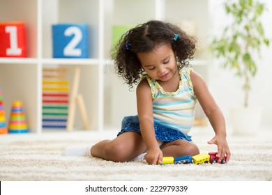 Kid girl playing toys at home or kindergarten