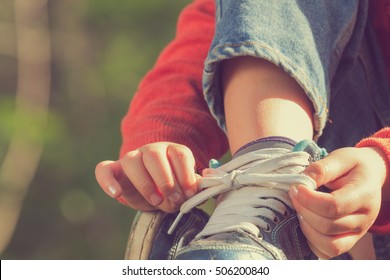 Kid Girl Tying Her Shoes.