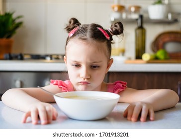 Kid Girl doesn’t want to eat vegetable puree soup. Healthly food. Vegetarian soup
