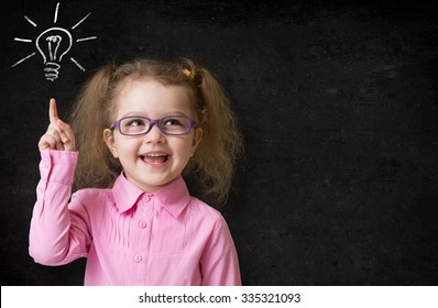 Kid In Glasses With Idea Lamp On School Chalkboard