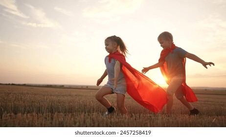 kid group superhero run. kids team happy family dream concept. childs group superhero run in red cape at sunset. portrait child superhero in the park. strength light fantasy concept