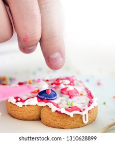 Kid Hand Decorating Valentine Cookie With Copy Space For Text.