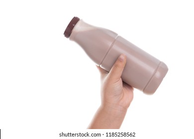 Kid Hand Holding Bottle Of Fresh Milk Chocolate Isolated On White Background.