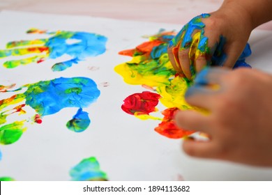 Kid Hand Learning Art And Color With Paint, Handprint And Fingerprint. Education Class For Child. Fun And Joy Activity For Creativity Development.