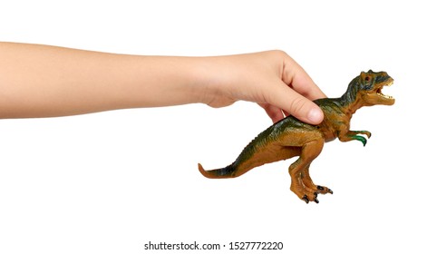 Kid Hand With Rubber Dinosaur Toy. Prehistoric Wild Animal, Danger Beast, T-Rex. Isolated On White Background.