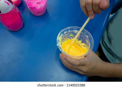 Kid Hand Stirring Sticky Mixture For Making Play Dough In Science Experiment. Home School Activity.