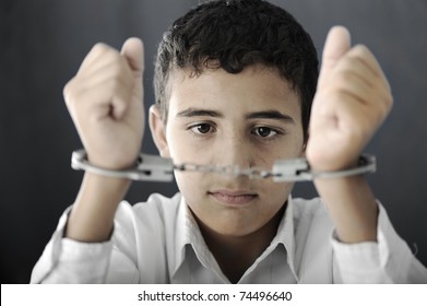 Kid With Handcuffs On Hands