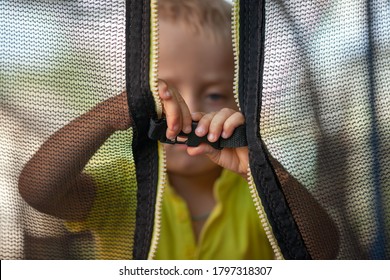 Kid Hands Closing The Trampoline Elastic Safety Belt And Safety Net. Concept Jump Safety.