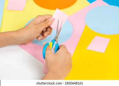 Kid Hands Cutting Colored Paper With Scissors. Education, Learning, Paper Craft, Entertainment At Home