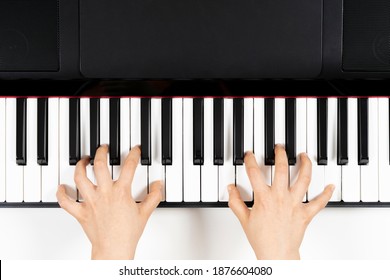 Kid Hands Learning To Play On The Piano. Top View