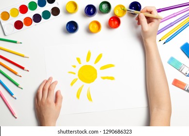 Kid Hands Painting At The Table With Art Supplies, Top View.