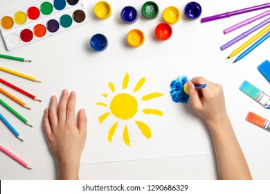 Kid Hands Painting At The Table With Art Supplies, Top View