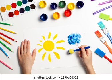 Kid Hands Painting At The Table With Art Supplies, Top View