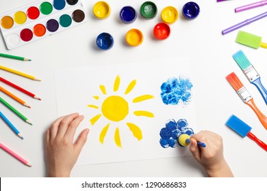 Kid Hands Painting At The Table With Art Supplies, Top View