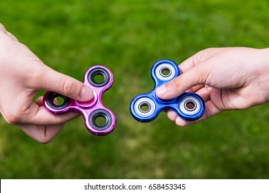 Kid hands with popular toy fidget spinners