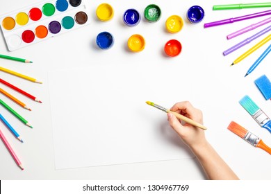 Kid Hands Start Painting At The Table With Art Supplies, Top View