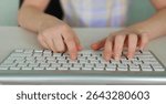 Kid hands use computer keyboard. Child Hands typing on the pc keyboard.
