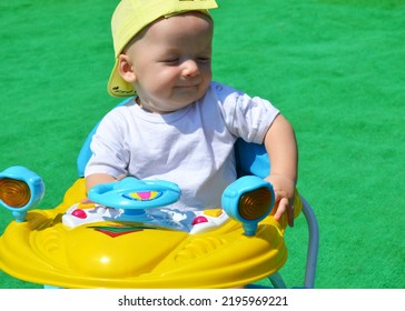 The Kid Is Happy Sitting Behind The Wheel Of His First Car