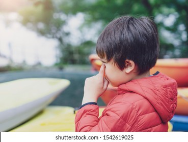 Kid Having Allergy, Itchy And Rubbing Eyes While Playing By The Lake, Little Boy Scratching Nose, Children Has Reflection Or Hay Fever From Pollen, Allergies And Asthma Issues In Kids