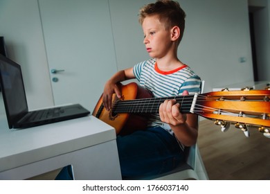 Kid Having Guitar Lesson Online, Remote Music Class