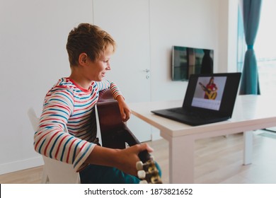 Kid Having Guitar Lesson Online, Teenage Boy On Remote Music Lesson