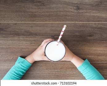 Kid Holding Glass Of Milk On Dark Rustic Background