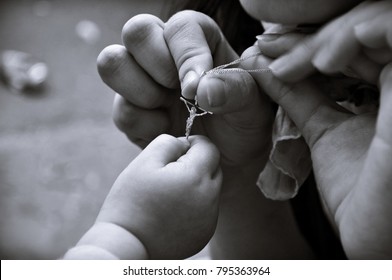 A Kid Holding A Jesus Cross Shown By An Adult - Teaching Religion