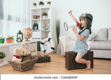 Kid Holding A Megaphone And Raising A Hand. She's Ready For The Next Round