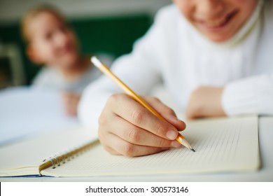 Kid Holding Pencil And Drawing In Notepad