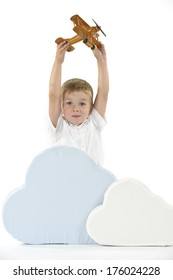 A Kid Holding A Plane Above Some Clouds.