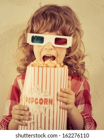 Kid holding popcorn in hands. Cinema concept. Retro style