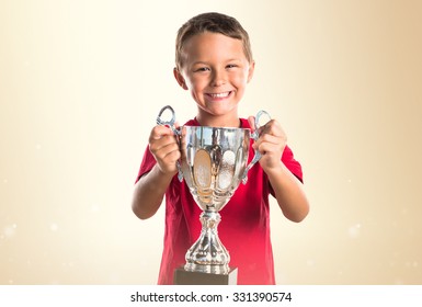 Kid Holding A Trophy