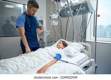 Kid in intensive care on breathing support in clinic - Powered by Shutterstock