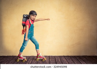 Kid with jet pack riding on roller skates. Child playing at home. Success, leader and winner concept